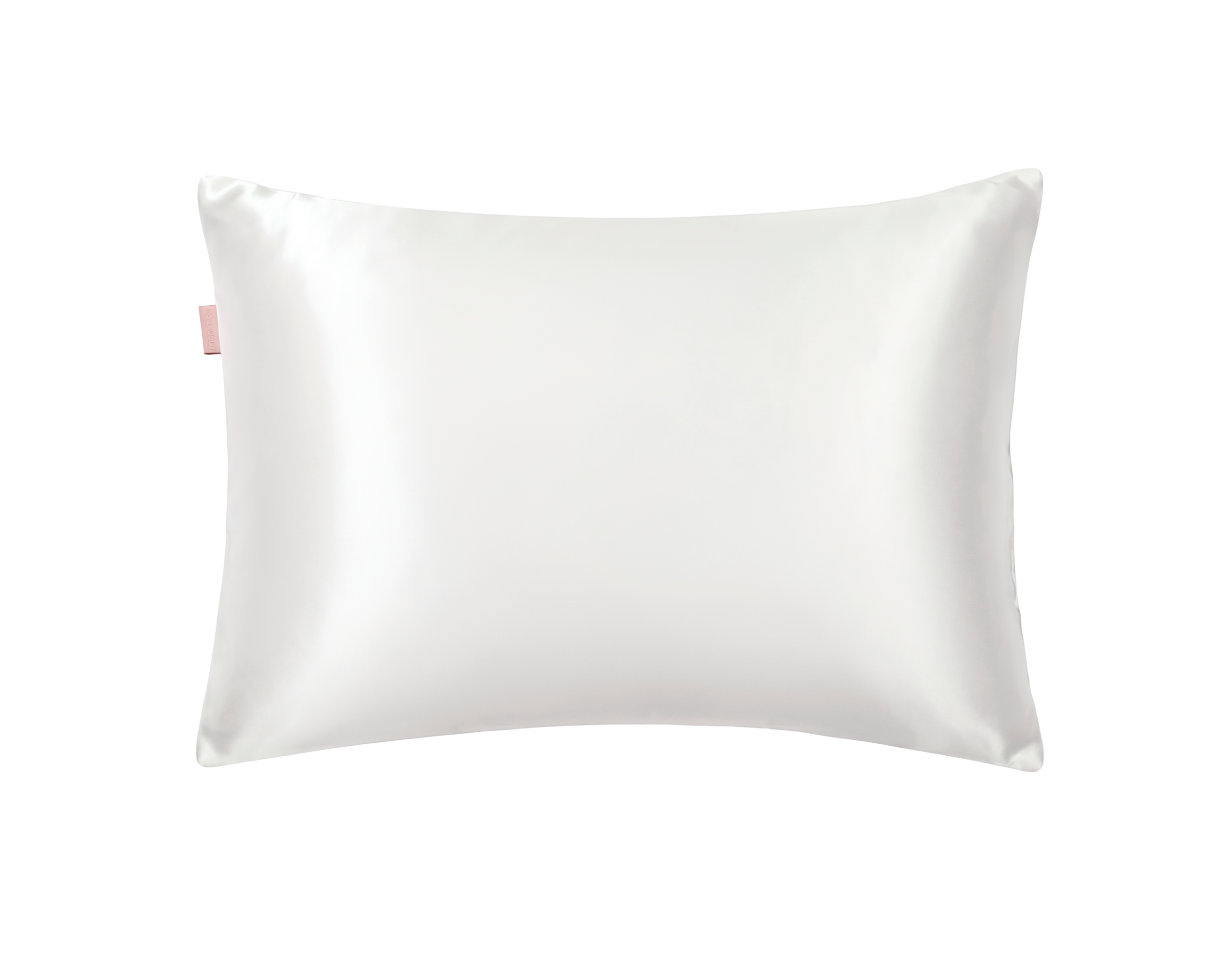 White satin pillow with a small pink tag on the left edge, close-up view of the fabric's sheen.