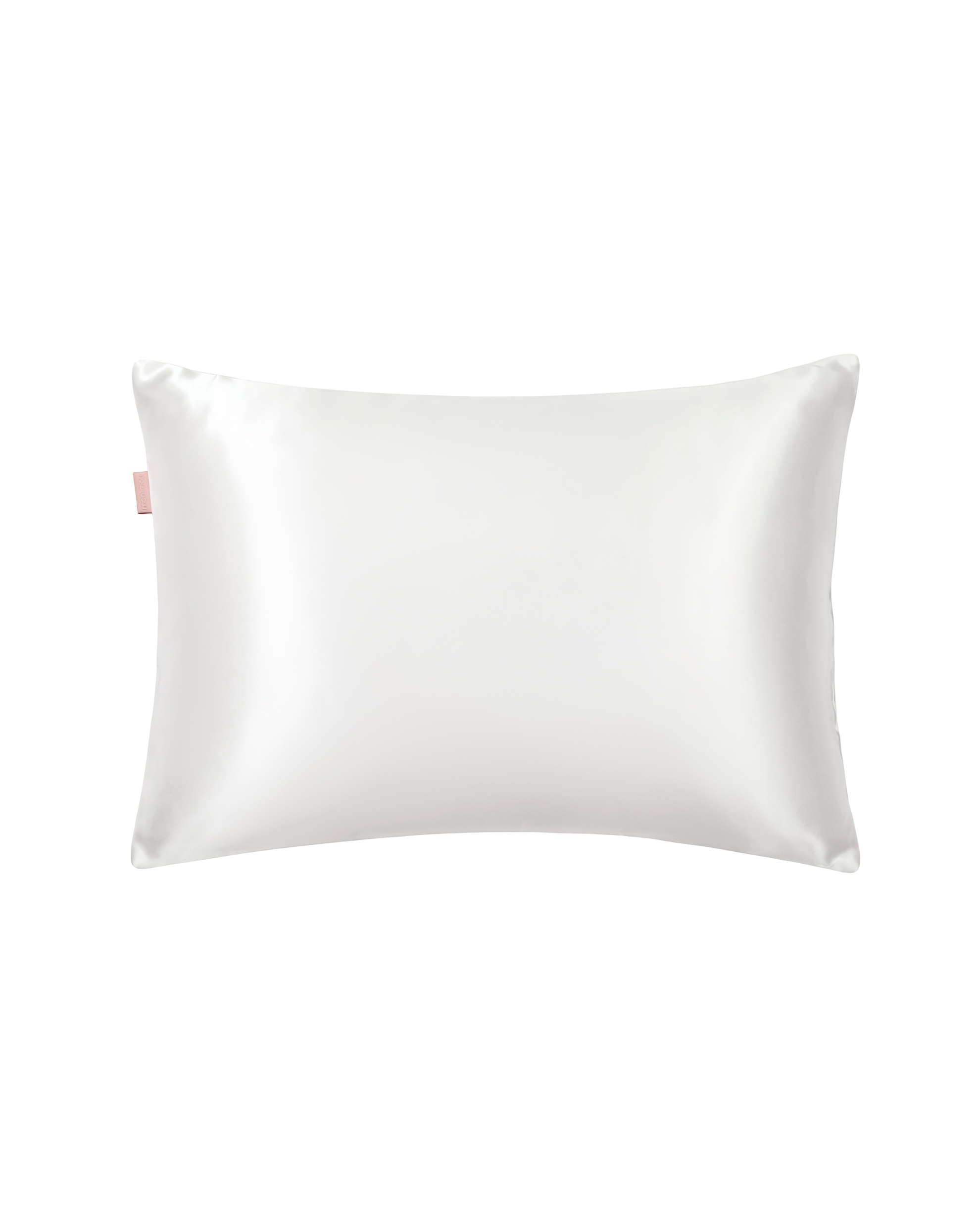 White satin pillow with a small pink tag along the left edge.