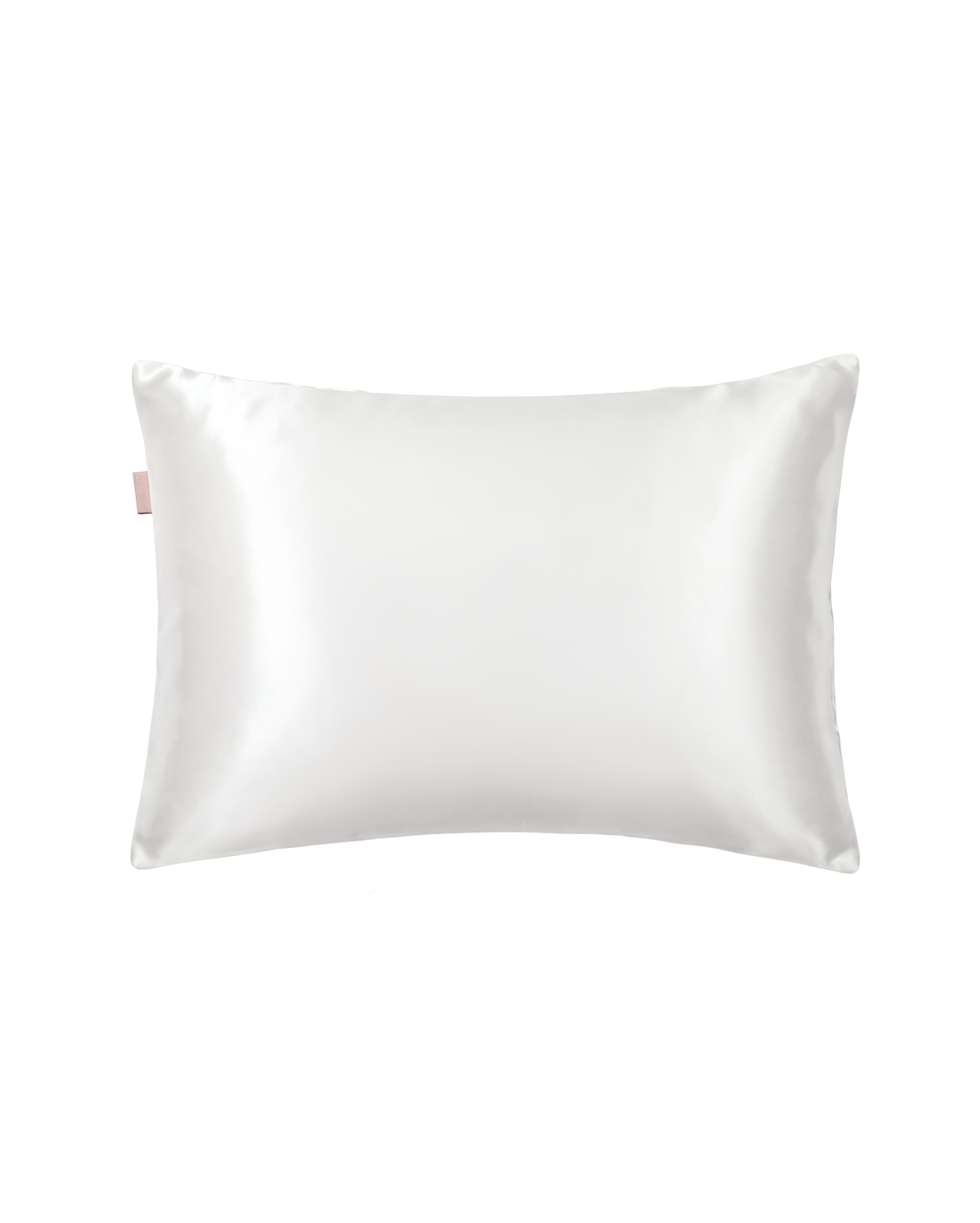 White satin square pillow against a plain background with a small pink fabric tag on the left edge