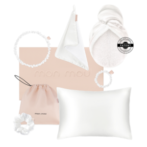 Mon Mou pastel nursery set: blush pink pillow, hooded towel, drawstring bag, fabric rings, and hair scrunchies on white background