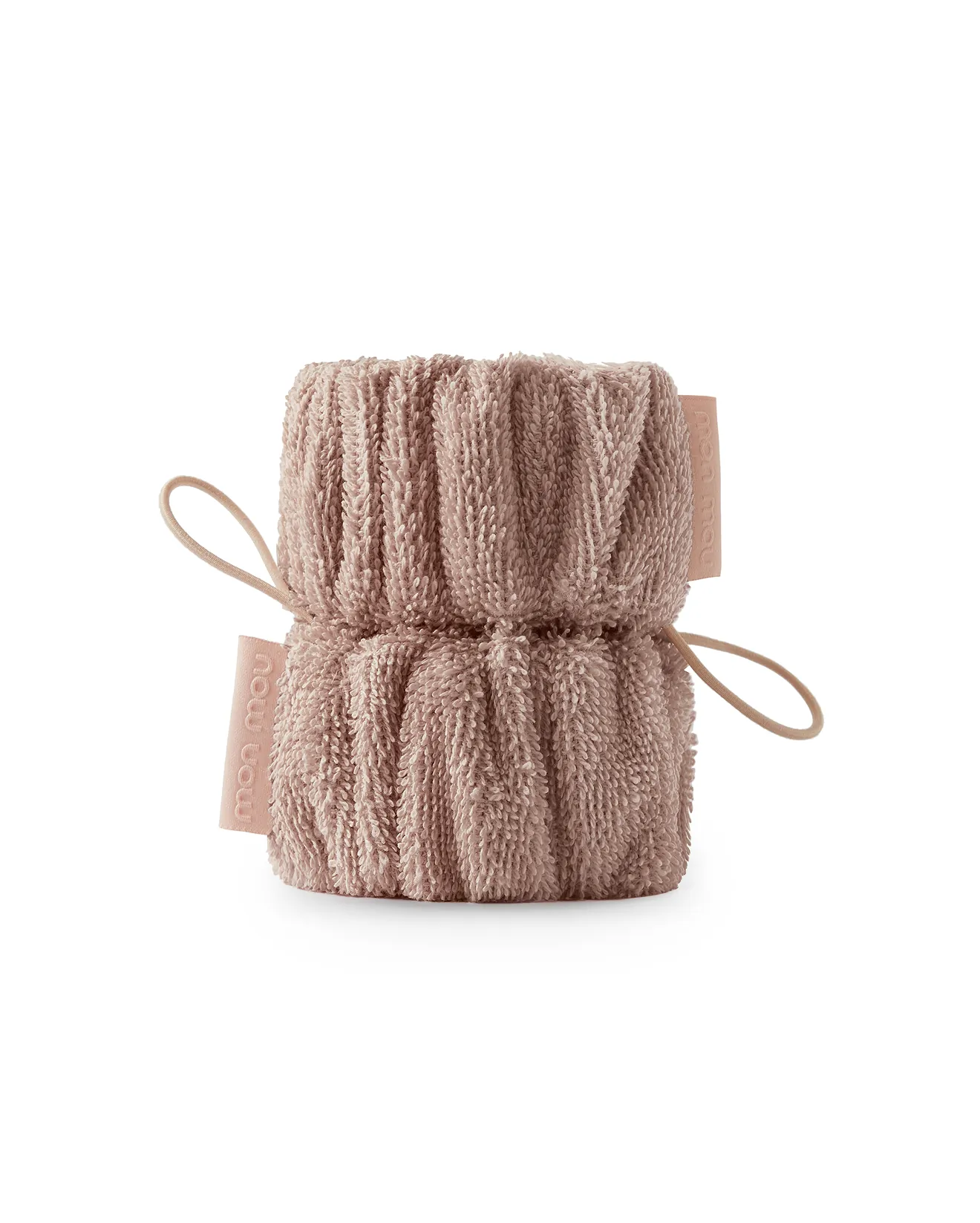 Soft pink plush towel rolled into a compact bundle with ribbon ties on the sides.