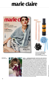 Marie Claire magazine cover showing a model in a gray cardigan; beauty products and hair accessories displayed to the right.