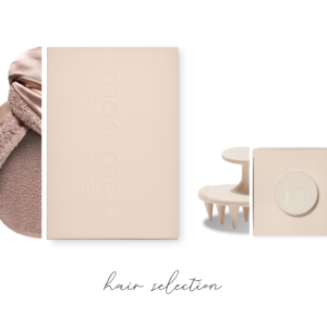 Beige beauty product boxes, a fluffy towel, and hair styling tools arranged in a flat lay for a hair care collection banner.