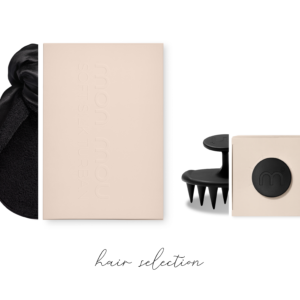 Beige packaging boxes with a black hair accessory and draped fabric on a white background for a hair collection display.