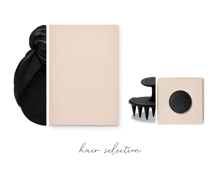 Beige packaging boxes with a black hair accessory and draped fabric on a white background for a hair collection display.