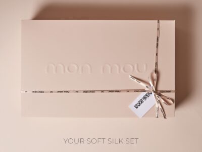 Pale pink gift box wrapped with a pale ribbon tied in a bow; at the bottom, text reads 'YOUR SOFT SILK SET'.