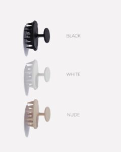 Vertical lineup of three silicone hair clips in black, white, and nude, each with a comb-like edge on the left.