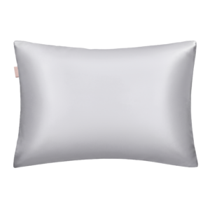 Light gray satin pillow with a small pink tag on the left edge.