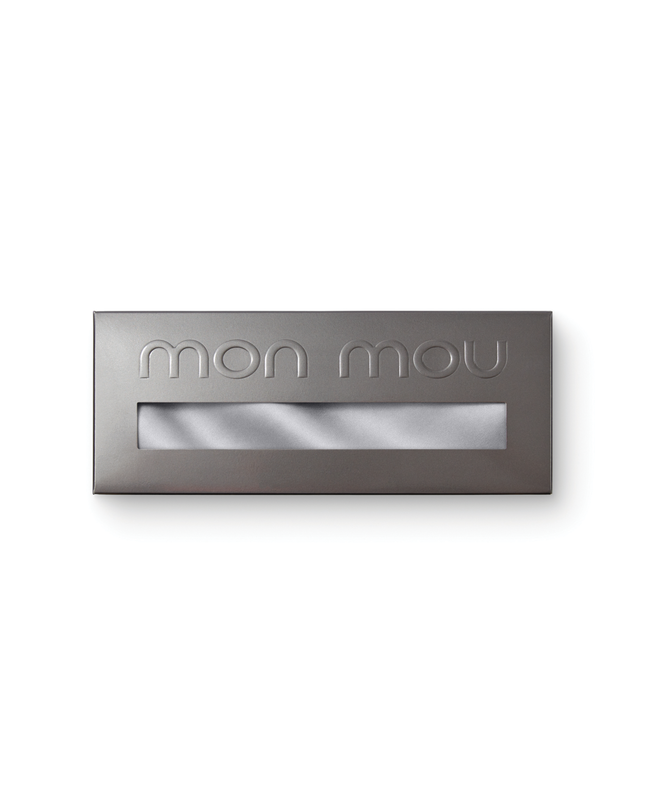 Close-up of a dark gray metallic box with a rectangular window and embossed 'mom you' along the top edge.