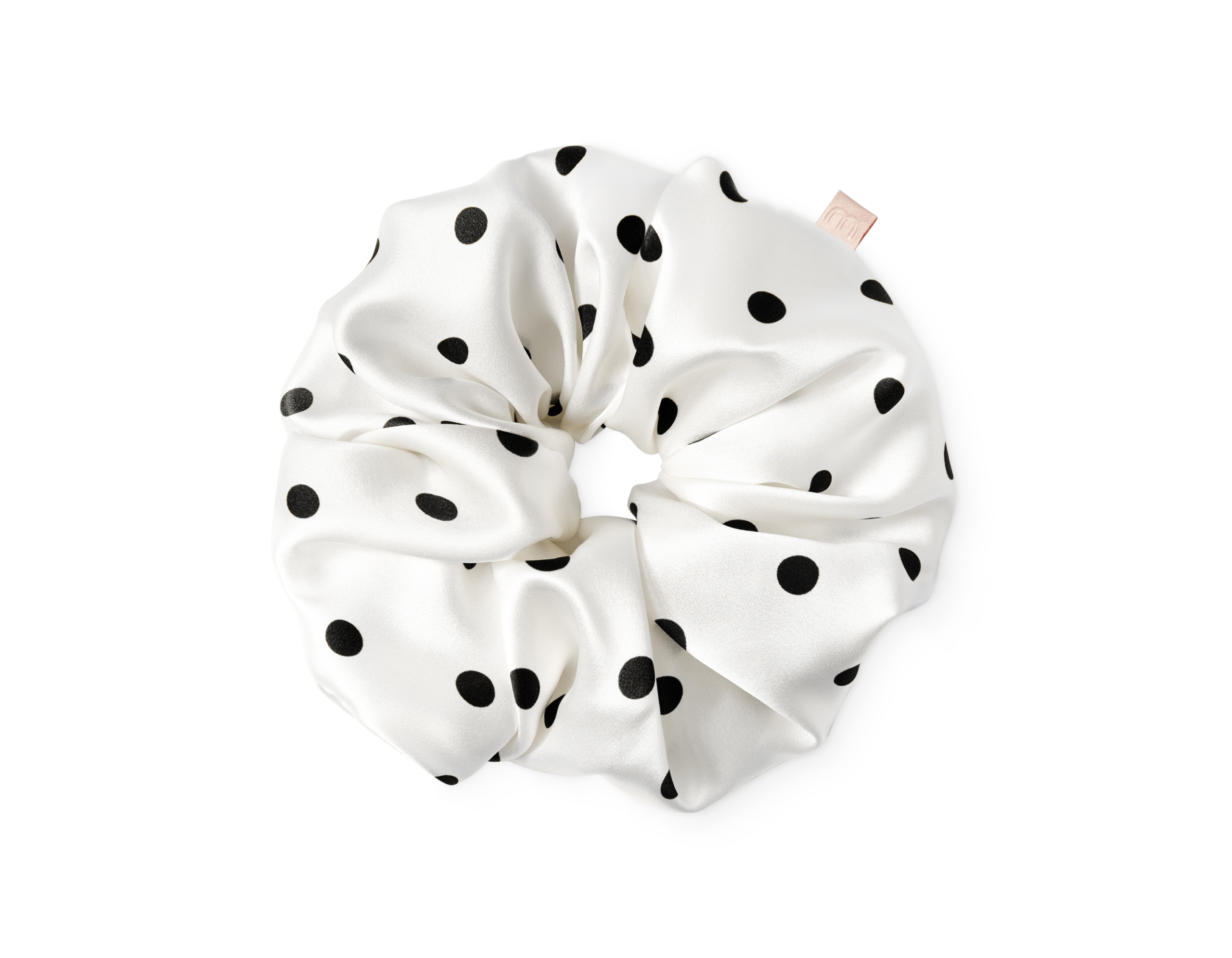 White satin hair scrunchie with black polka dots tied in a knot.