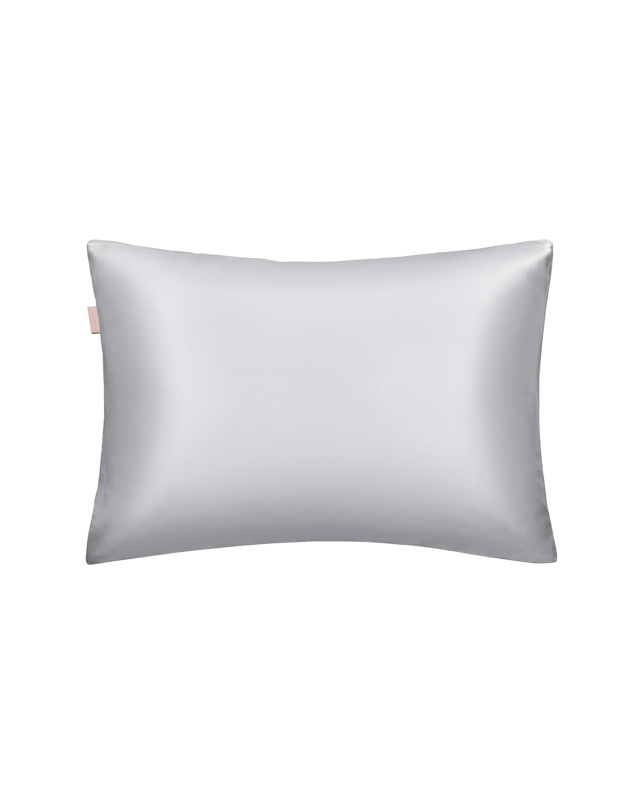 Close-up of a light gray satin pillow with a small pink tag on the left edge against a white background