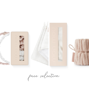 Assorted blush-pink beauty packaging, scrunchies, a satin bag, and knit accessories arranged on a white background.