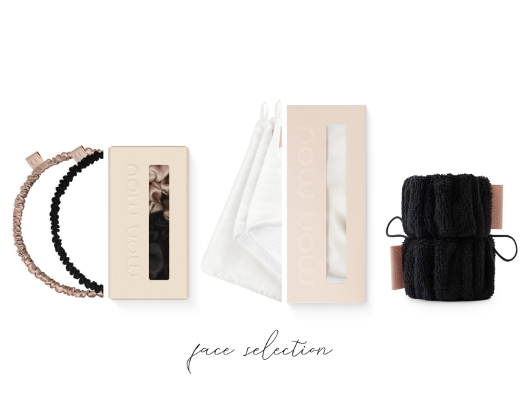 Arrangement of pale-beige cosmetic boxes with nude and black scrunchies, white fabric masks, and a black textured towel on a white background, part of a 'face reflection' collection.