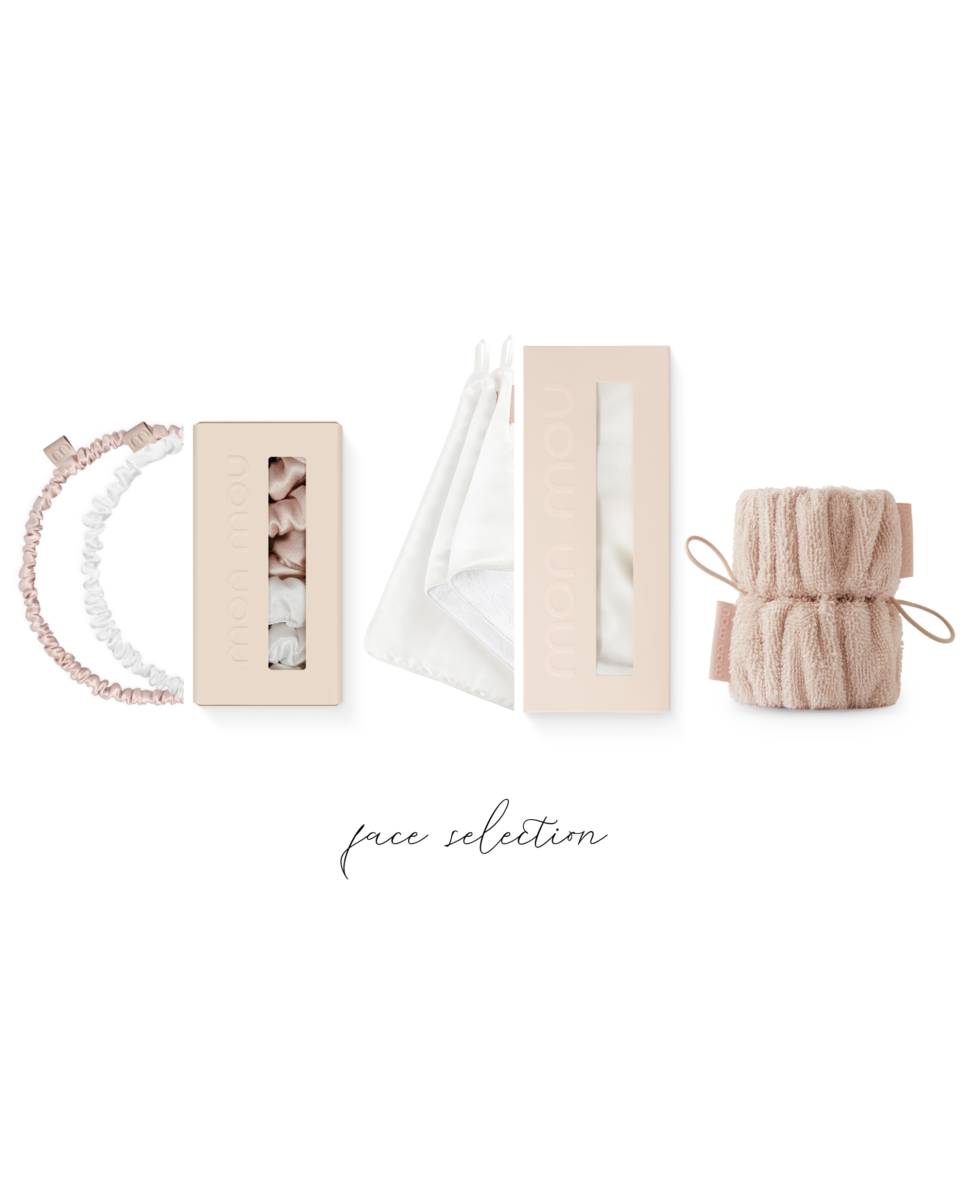 Pastel pink beauty packaging and accessories arranged in a bottom-edge collage on a white background (boxes, ribbons, scrunchies, and soft knit items).