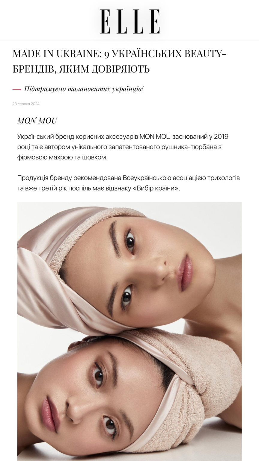 Two women with beige spa towels wrapped around their heads, posing for a beauty editorial image.