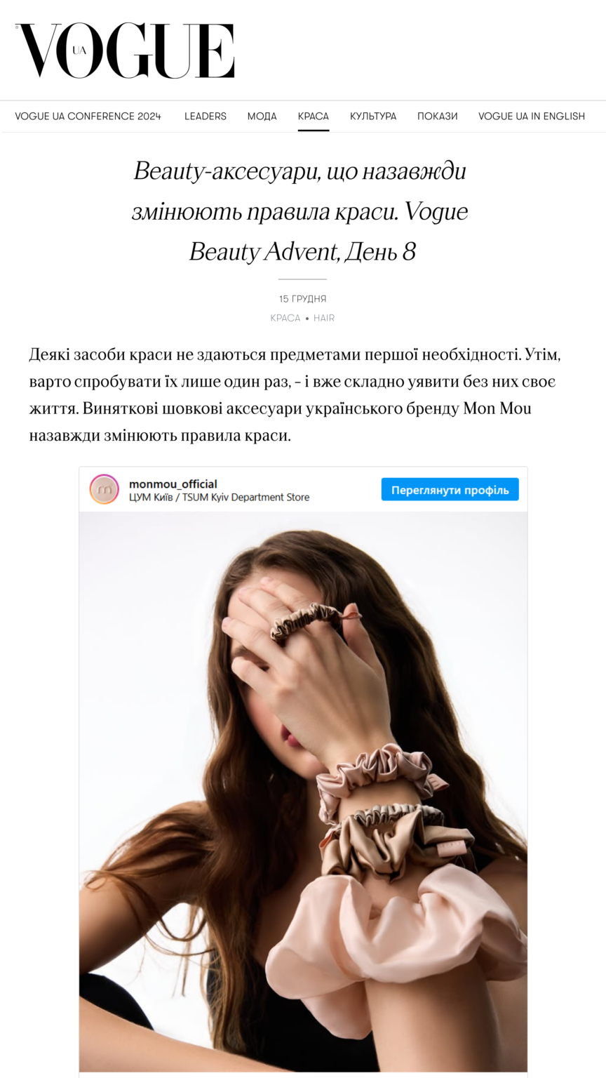 Model with long brown hair covering part of her face, wearing pink satin scrunchies on her wrists on a white background.
