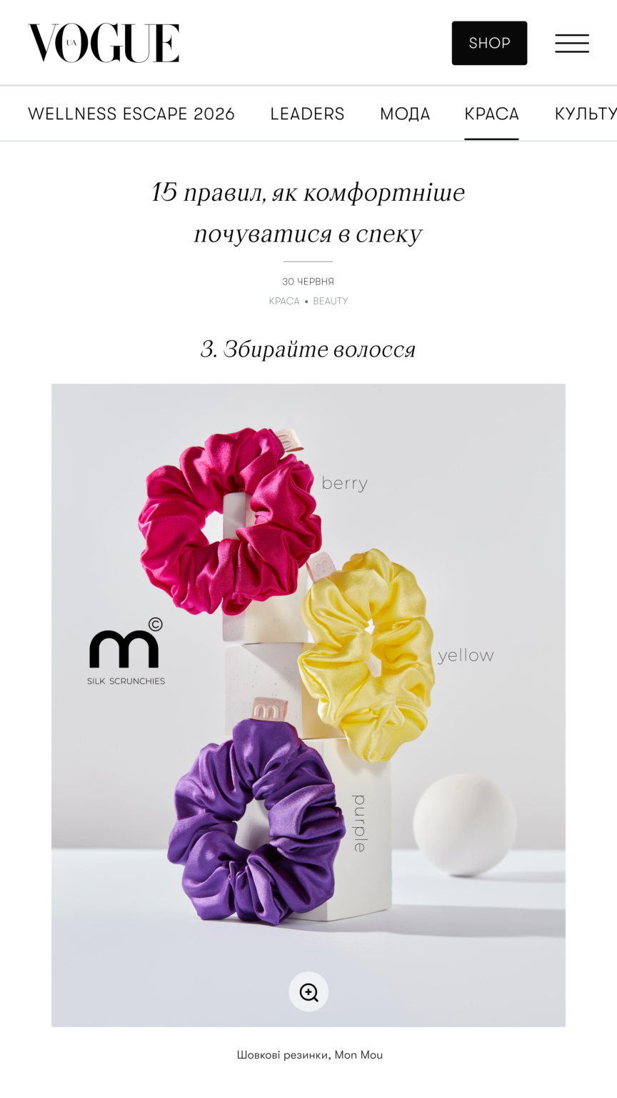 Product photo of silk scrunchies in pink, purple, and yellow arranged around a white display with a black 'm' logo and soft grey background.